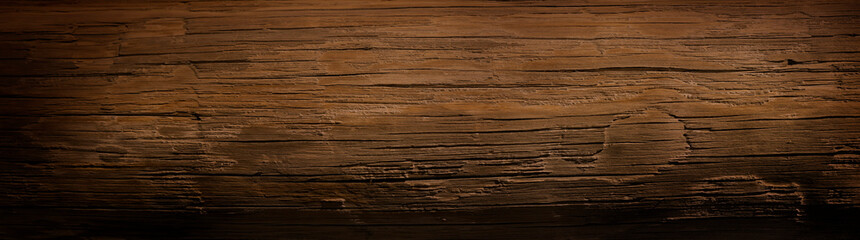 Fototapeta premium Dark stained wood board with grain knots and texture