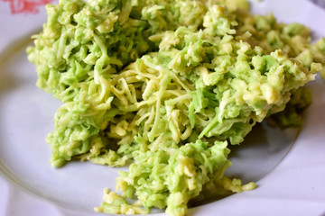 Green Avocado puree on a white plate