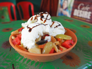 Fruit salad with Apple watermelon mango and grapes with white vanilla ice cream. Delicious and...