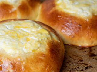 vatrushka, a round bun with cottage cheese filling. Traditional baking of Russian cuisine. Close-up, side view