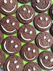 Chocolate cookies with smilies in top.