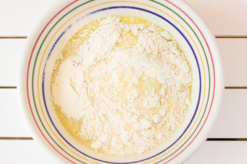 Bowl with beaten eggs milk flour for cooking pancakes - 340400268