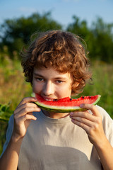 Boy eating watermelon summer outdoors