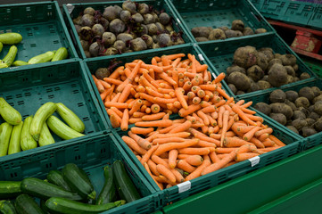 zucchini, carrots, beets, vegetables on the counter in boxes in the store for sale