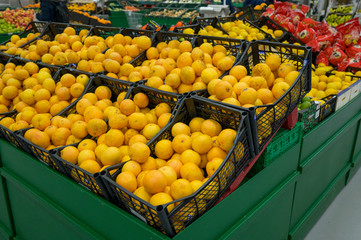 KIEV, Ukraine, February 25, 2020, ripe lemons in boxes on the shelves of a supermarket