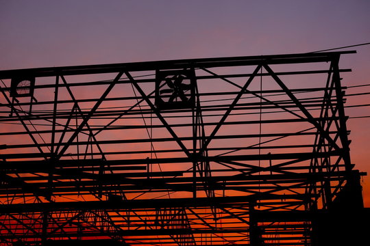 Sunset in the background of a building skeleton