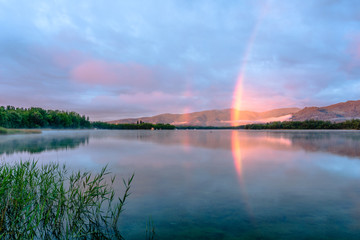Naklejka na ściany i meble Morning rainbow in the lake (Lake of Banyoles, Catalonia, Spain)