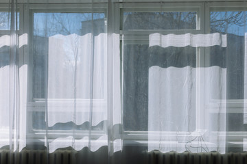 White tulle on window. Interior design.