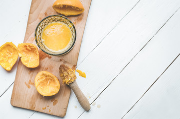 Fresh orange in a glass on a wooden board on a white wooden table. Vitamin C. Health concept. Top iew