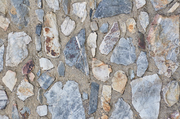 Photograph showing the detail of a stone wall corresponding to a house in the country. Typical stone constructions. Granite texture shown. Ideal for backgrounds and presentations.