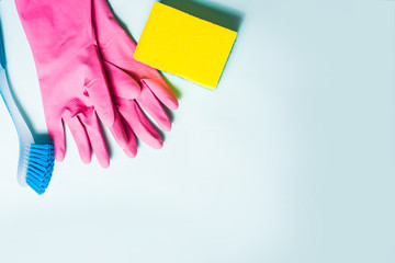 cleaning attributes, gloves, sponge brush, items for washing, top view on a blue background, for text