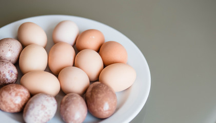 Eggs. Eggs on the plate. Table. Easter. Holiday. Eggs lying on a plate and behind them a table. Chicken.