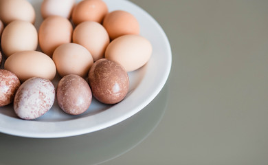 Eggs. Eggs on the plate. Table. Easter. Holiday. Eggs lying on a plate and behind them a table. Chicken.