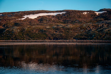 A beautiful view of the lake and mountains at sunrise. Summer in a lap circle.
