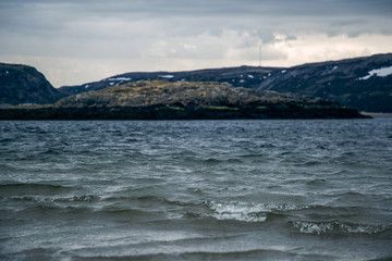 View of the sea and mountains in cloudy weather. Barents Sea Russian North.