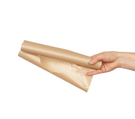roll of brown parchment paper for baking food in female hand
