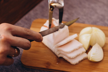 slice a piece of Ukrainian pork fat and serve on a wooden board