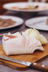 slice a piece of Ukrainian pork fat and serve on a wooden board