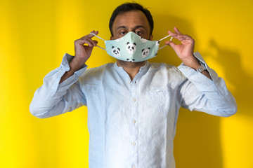 Male model wearing home made face mask to avoid infection from corona virus during corona pandemic...