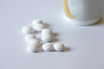 Pot of tablets and their bottle.