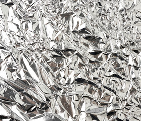 texture of shiny crumpled piece of gray foil, packaging material for food and objects