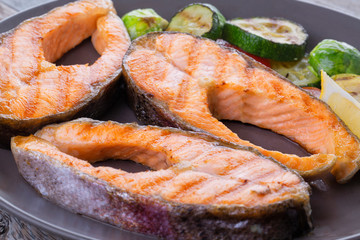 Three grilled salmon steaks with mix of vegetables