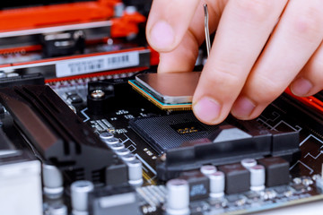 Fototapeta na wymiar The process of installing in CPU microprocessor to motherboard socket