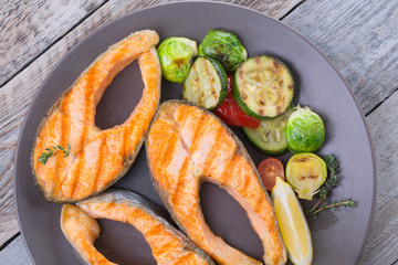 Three grilled salmon steaks with mix of vegetables
