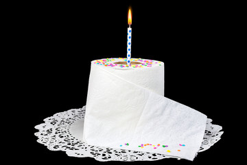 birthday candle in roll of toilet paper on lace paper doily with candy confetti sprinkles - obrazy, fototapety, plakaty
