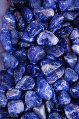 Different polished blue natural stones are in the boxes.