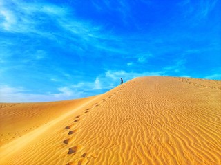 Walking in sand dunes on desert