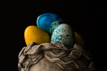 Easter painted eggs in a stone vase