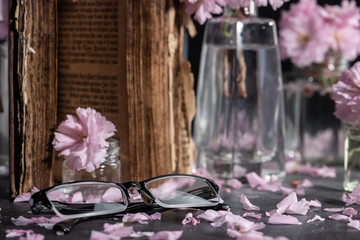 Cherry blossom, sakura flowers in a glass jar with petals and glasses