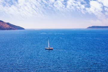 Sky and sea, blue Mediterranean landscape with one sailboat on water. Montenegro, view Adriatic Sea from Kotor Bay near Herceg Novi city . Travel concept. Loneliness among sky and water