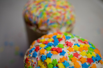 two Easter buns with colorful glaze decorations on top