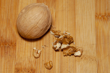 a whole walnut next to a split one on a light background