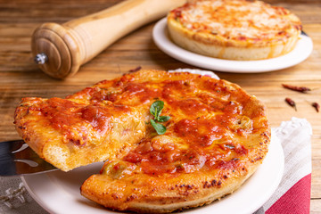 Chicago Style Deep Dish Cheese Pizza with Tomato Sauce, on wooden background