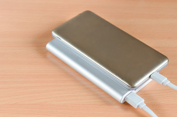 Close-up of usb  fast charge power bank charging a smartphone .