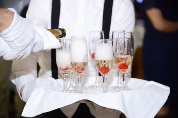waiter serving champagne at restaurant