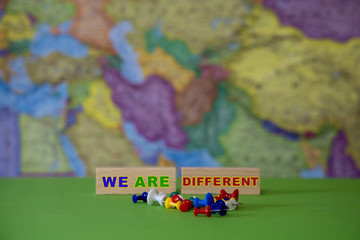 Different colors of office supplies against the background of the geographical map of the world