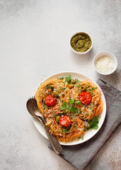 Italian pasta with cherry tomatoes, pesto and parmesan cheese