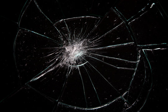 Broken glass with lots of cracks, studio shot with black background