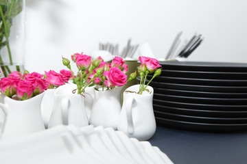 Serving table. Small twigs of spray roses are used to decorate the table
