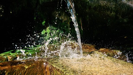 Water fountain in the park, the water falling down and splashing 
