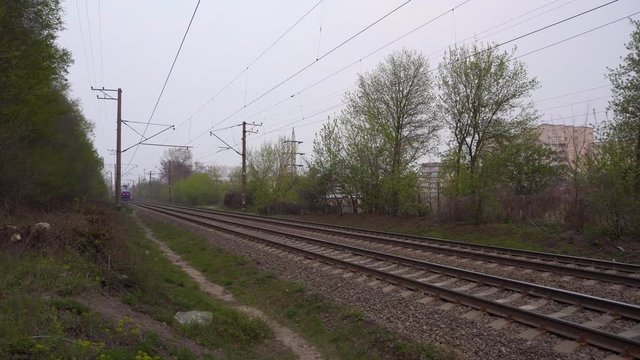 Kyiv, Ukraine - April, 2020: Electric old blue passenger train is riding in dusk.