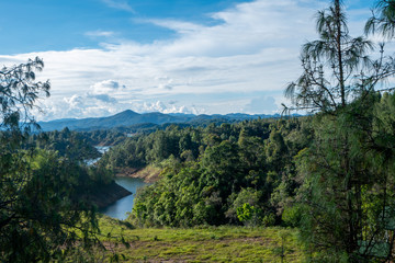 River between lush mountains that reach the Guatapé dam, Antioquia, Colombia