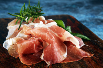Italian prosciutto crudo or jamon with rosemary. Raw ham appetizer