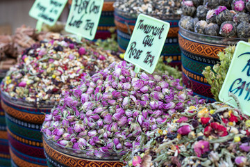 Dried herbal teas close-up. In the round box in front of the store. Healthy and delicious in different varieties and flavors.