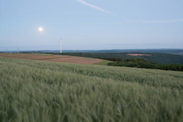 Moonrise behind a windmill