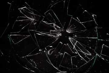 Broken glass on black background with lots of glass splinters